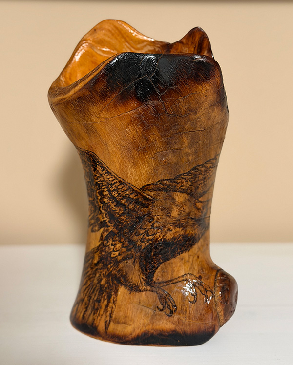 Hand-carved wooden vase with pyrography decor