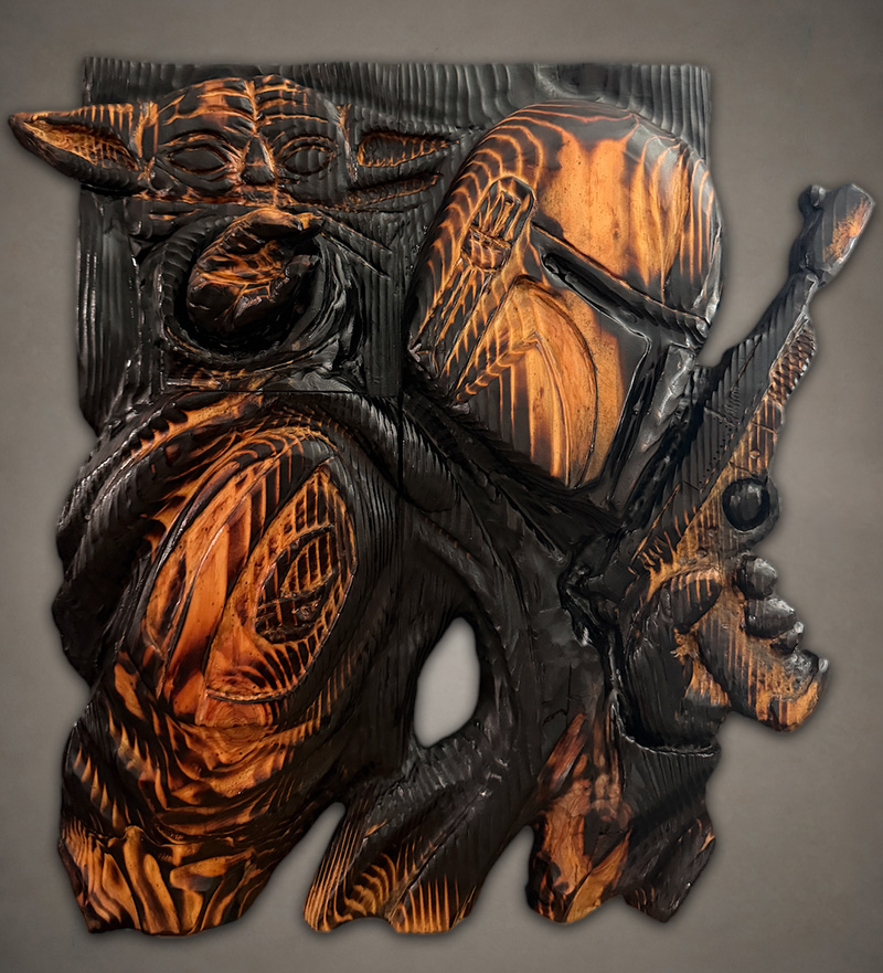 Wooden wall art featuring mandalorian and grogu baby yoda with carved and burned details